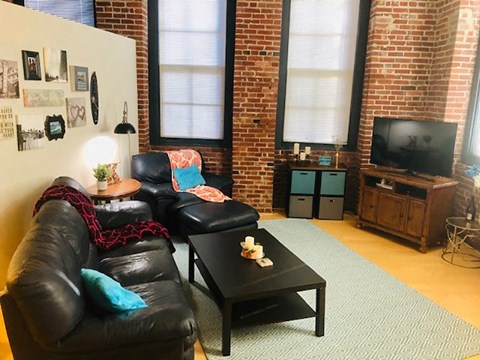 a living room with leather furniture and a television